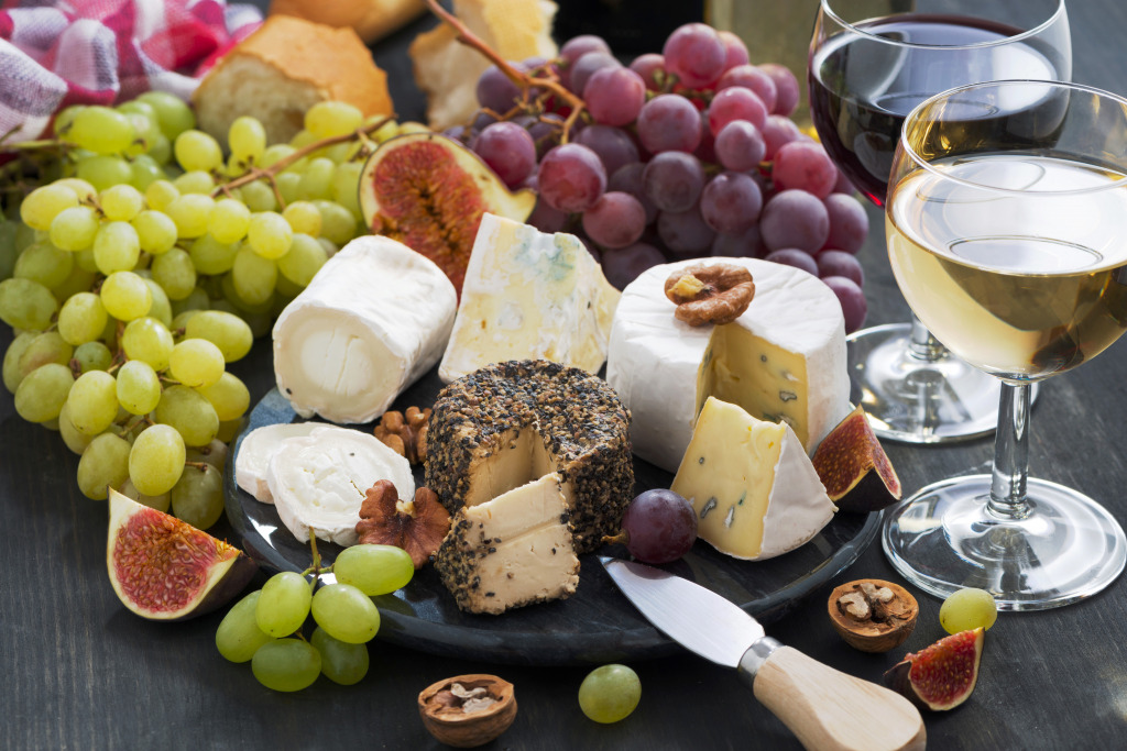 Soft Delicacy Cheeses and Snacks For Wine On A Dark Background, Close-Up jigsaw puzzle in Food & Bakery puzzles on TheJigsawPuzzles.com