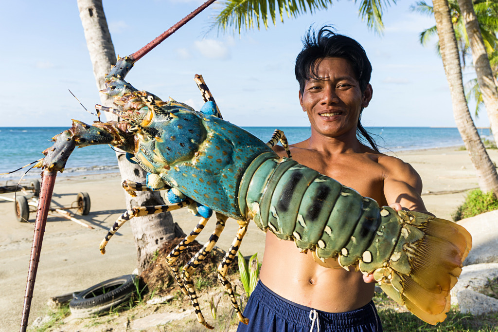 Fisherman Showing the Lobster, Malaysia jigsaw puzzle in People puzzles on TheJigsawPuzzles.com